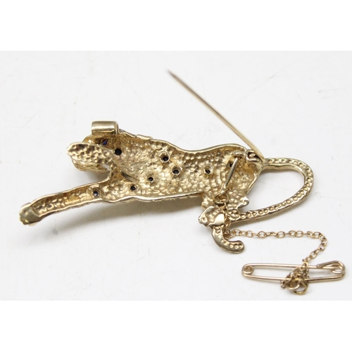 1195 - Retro 9ct gold brooch formed as a leopard set with small blue sapphires and diamond chip collar, mar... 