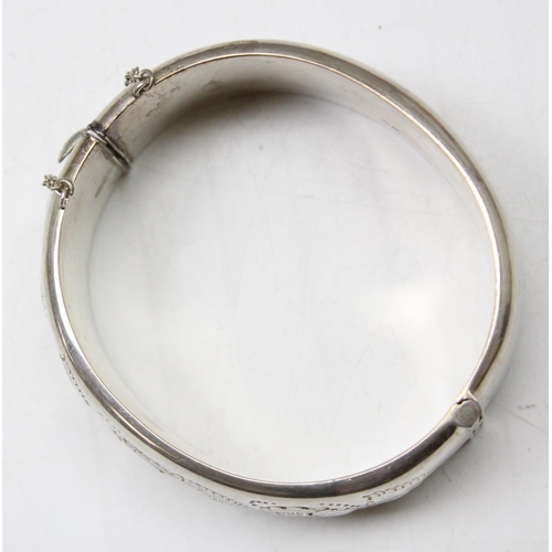 1199E - A vintage Sterling silver cuff bangle with embossed decoration, Birmingham 1964, approx 38.49g gross