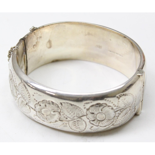 1199E - A vintage Sterling silver cuff bangle with embossed decoration, Birmingham 1964, approx 38.49g gross