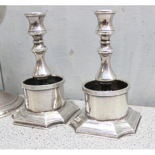 1047 - A mid 20th century silver plated travelling communion chalice and a pair of silver plated candlestic... 