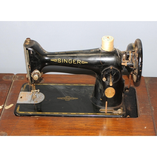 163 - Vintage singer sewing machine on wooden & cast iron pop up base