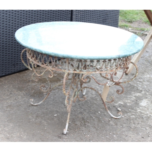 367 - An antique style marble topped garden table with distressed metal base, approx 72cm in diameter