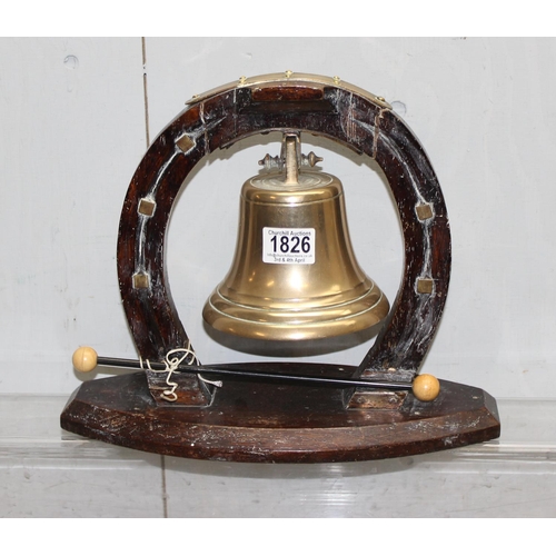 1826 - A vintage brass table bell on wooden horseshoe shaped stand, approx 33cm wide