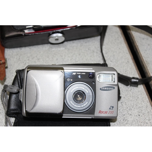 719 - Mixed lot of cameras and lenses to include a collectable Polaroid SX-70 land camera model 2 with lea... 