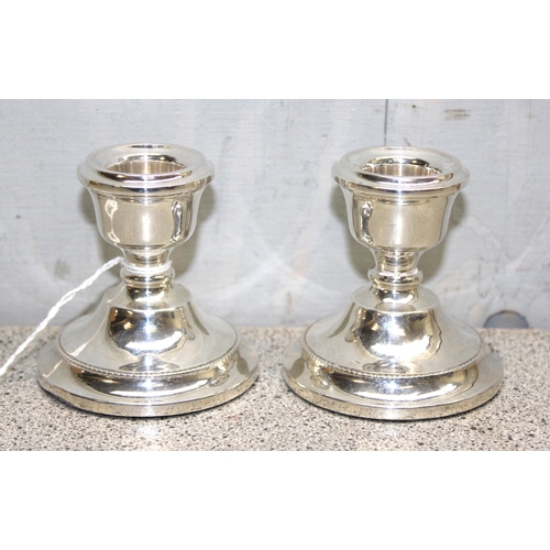 1069 - Pair of weighted sterling silver dwarf candlesticks hallmarked for Birmingham 1965 with rubbed maker... 