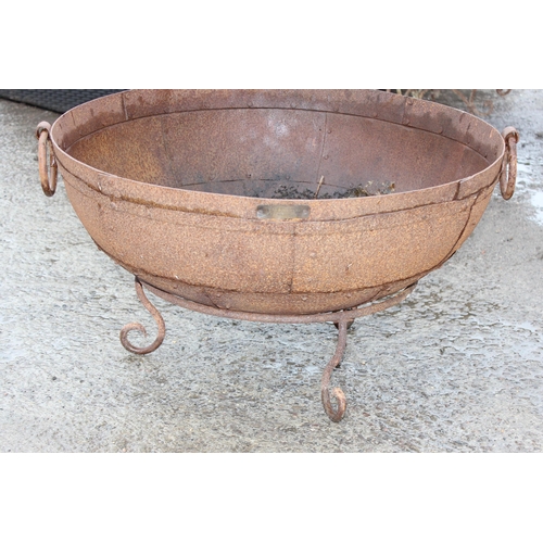 353 - A rusty metal garden fire pit or brazier on metal stand, approx 71cm in diameter