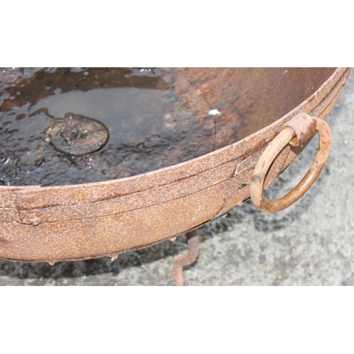 353 - A rusty metal garden fire pit or brazier on metal stand, approx 71cm in diameter