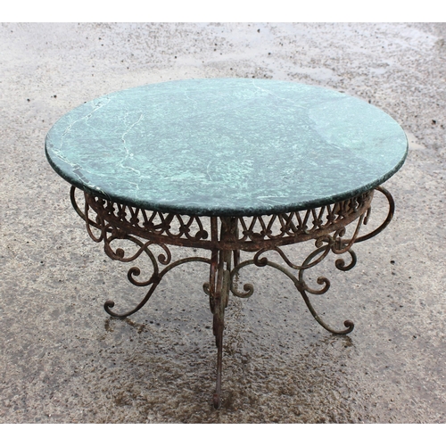 367 - An antique style marble topped garden table with distressed metal base, approx 72cm in diameter