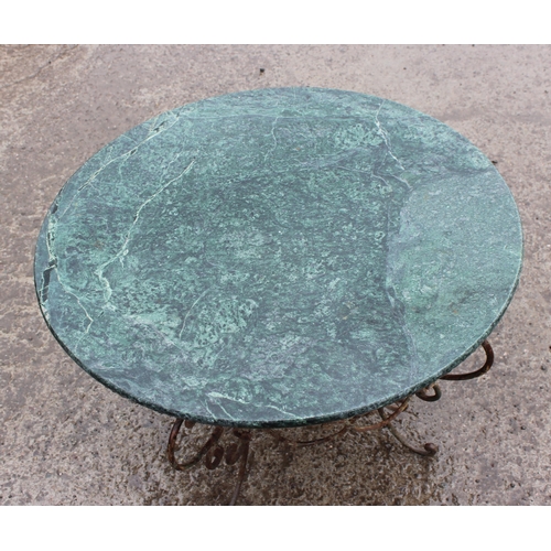 367 - An antique style marble topped garden table with distressed metal base, approx 72cm in diameter