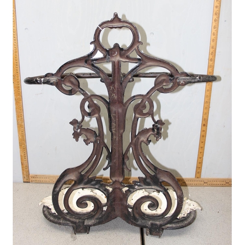 164 - A 19th century cast iron stick stand with drip tray, both pieces with various marks to inc the Victo... 