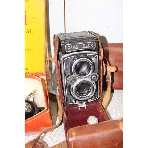 717 - A vintage Rolleiflex TLR camera in original leather case with a number of extras to inc a Rolleipark... 