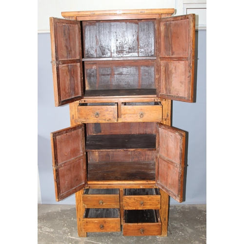 18 - A large Chinese hardwood cabinet, likely Elm with hand wrought iron fittings, likely 19th century, a... 