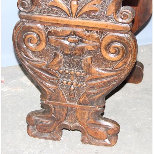 28 - An antique hall chair with deep quality carved details, approx 100cm tall