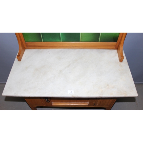 4 - An early 20th century Pine marble topped wash stand with tile back, approx 91cm wide