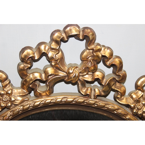 402 - A pair of antique style shield shaped gilt framed mirrors, each approx 65cm tall