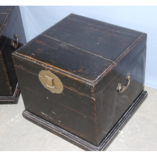 44 - A pair of Chinese black painted wooden storage boxed with brass clasps, unknown age, approx 50cm squ... 