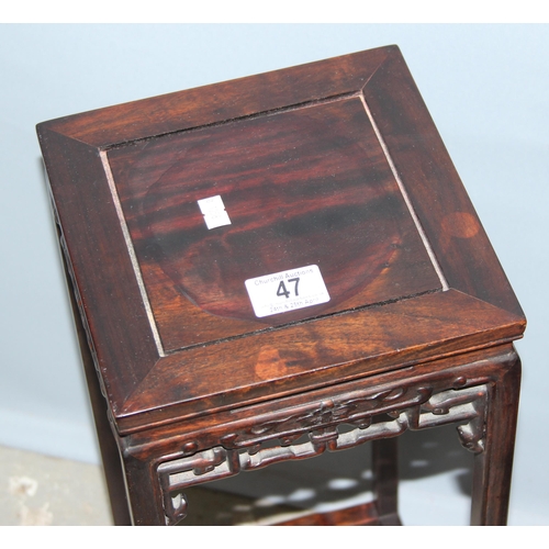 47 - A small Chinese carved hardwood table or jardinière stand with plain top and carved fretwork support... 