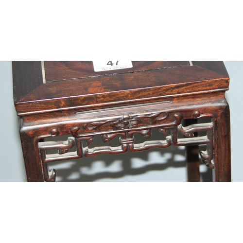 47 - A small Chinese carved hardwood table or jardinière stand with plain top and carved fretwork support... 