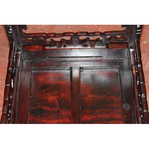 47 - A small Chinese carved hardwood table or jardinière stand with plain top and carved fretwork support... 