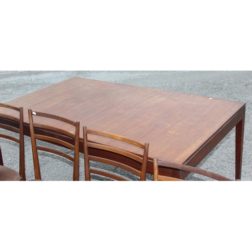 49 - A retro extending Meredew dining table and 5 chairs, the table approx 152cm x 92cm when closed