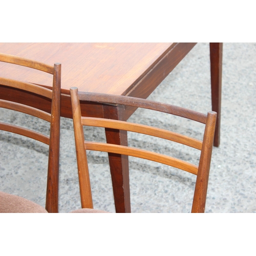 49 - A retro extending Meredew dining table and 5 chairs, the table approx 152cm x 92cm when closed