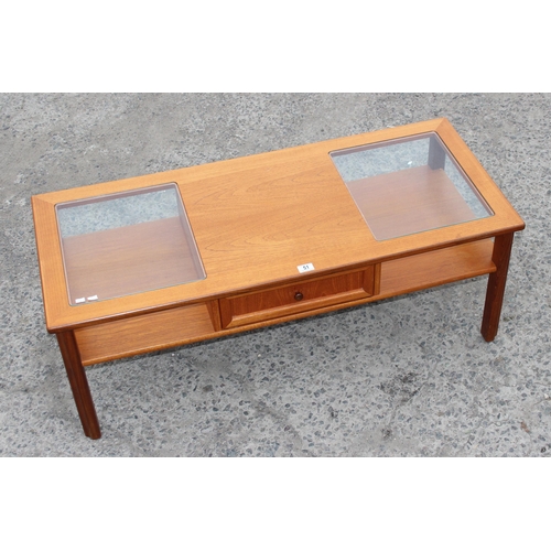 51 - A retro G-Plan glass topped coffee table with drawer, approx 122cm wide