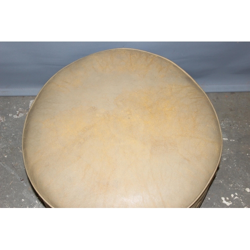 62 - A large light tan leather coloured pouffe or foot stool