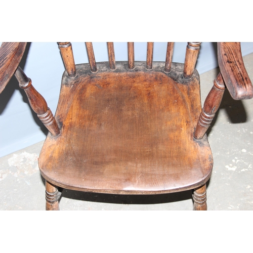 63 - A 19th century farmhouse stick back armchair