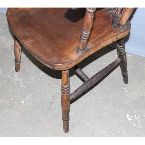 63 - A 19th century farmhouse stick back armchair