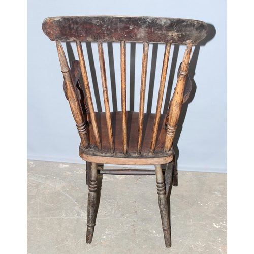 63 - A 19th century farmhouse stick back armchair