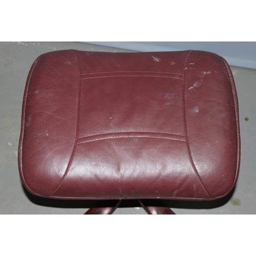 7 - A retro Burgundy leather Scandinavian style reclining office chair and footstool, Ekornes type