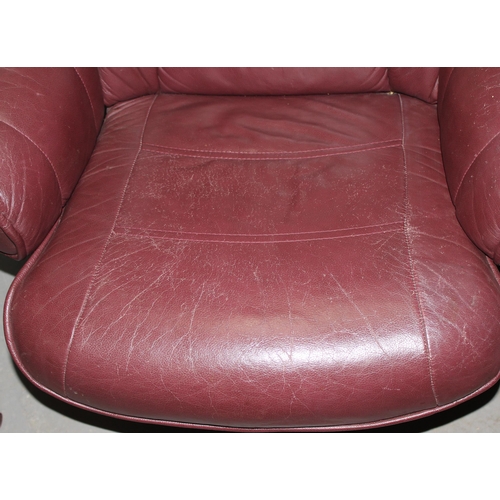 7 - A retro Burgundy leather Scandinavian style reclining office chair and footstool, Ekornes type