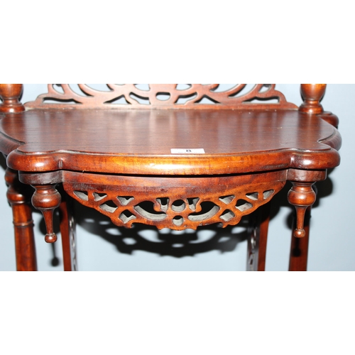 8 - An unusual antique style hall table with fretwork details and magazine rack and drawer to base, appr... 