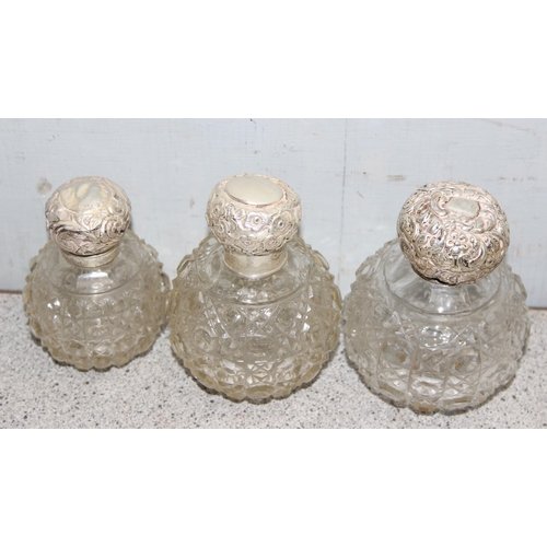 1023 - 7 assorted smaller grenade shaped perfume bottles, 6 with silver tops, various dates and makers, mai... 