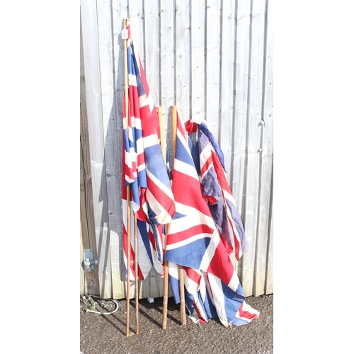 1403 - 7 vintage c.1940's and 1950's British made Union Jack parade flags, 5 on poles, the largest approx 1... 