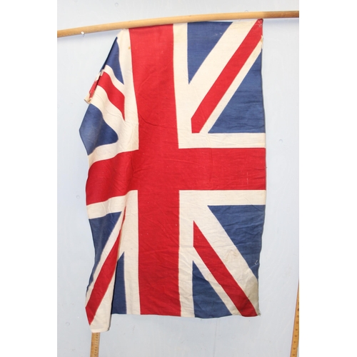 1403 - 7 vintage c.1940's and 1950's British made Union Jack parade flags, 5 on poles, the largest approx 1... 