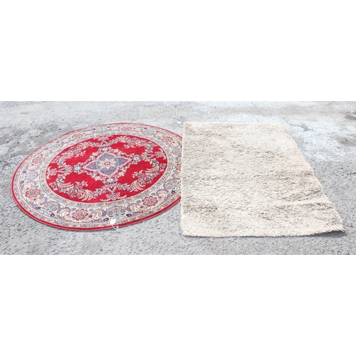 205 - Circular red ground rug with floral decoration approx. 170cm diameter & a shaggy beige ground rug ap... 