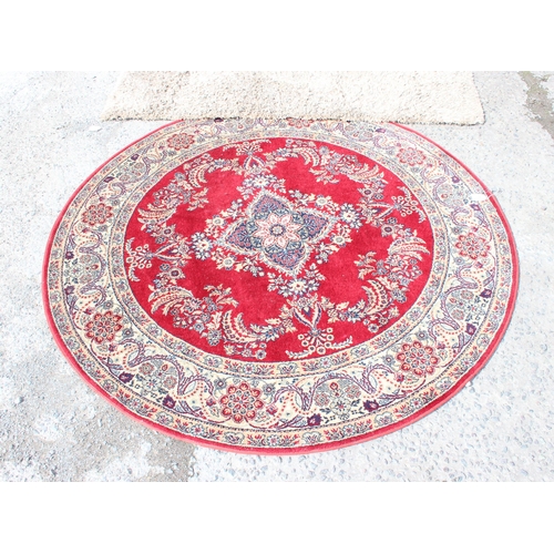 205 - Circular red ground rug with floral decoration approx. 170cm diameter & a shaggy beige ground rug ap... 