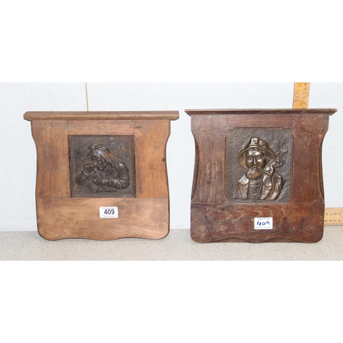 409 - 2 wooden framed metal relief plaques, copper embossed copper plaque of a fisherman and a cast iron p... 