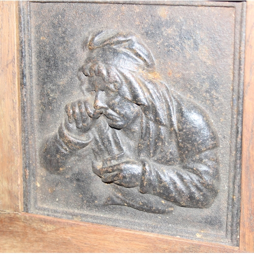 409 - 2 wooden framed metal relief plaques, copper embossed copper plaque of a fisherman and a cast iron p... 