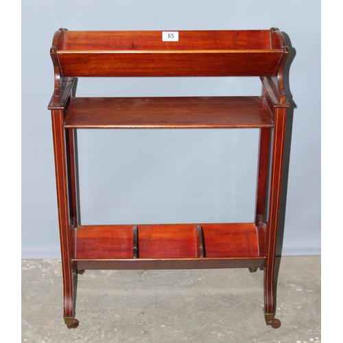 85 - An Edwardian Sheraton revival 2 tier mahogany book trough with brass and ceramic castors