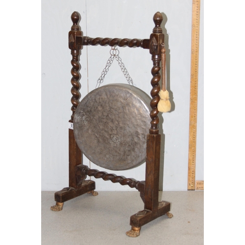 93 - Large early 20th century dinner gong & mallet mounted in oak barley twist frame with lion paw feet