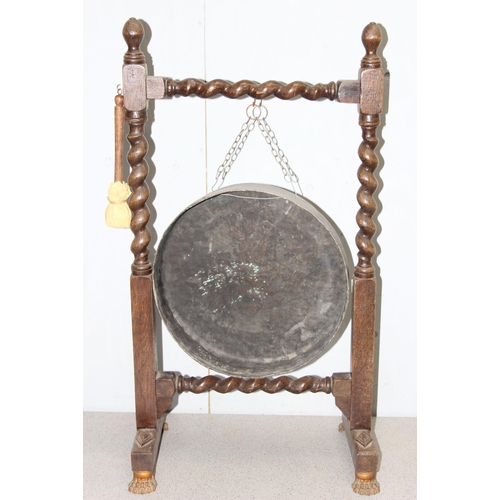 93 - Large early 20th century dinner gong & mallet mounted in oak barley twist frame with lion paw feet