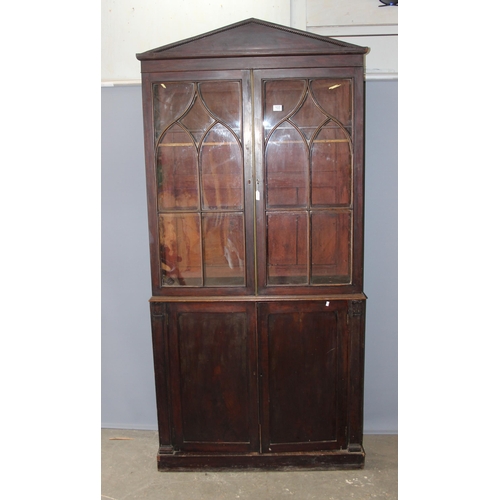 105 - Antique mahogany glazed bookcase over large shelved cupboard, approx 220cm