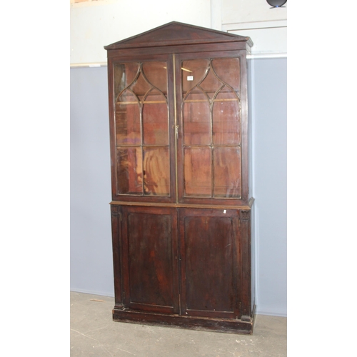 105 - Antique mahogany glazed bookcase over large shelved cupboard, approx 220cm