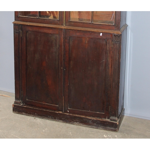 105 - Antique mahogany glazed bookcase over large shelved cupboard, approx 220cm