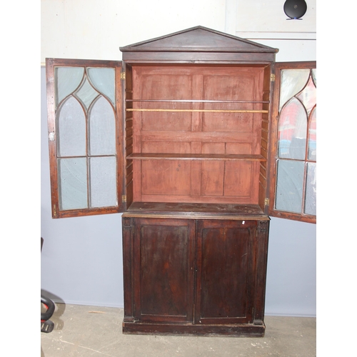 105 - Antique mahogany glazed bookcase over large shelved cupboard, approx 220cm