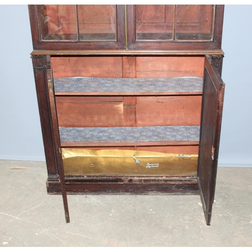 105 - Antique mahogany glazed bookcase over large shelved cupboard, approx 220cm