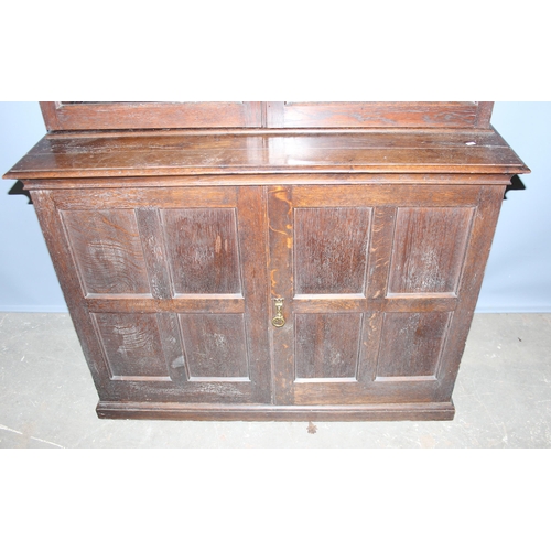 126 - Vintage oak glazed bookcase over double door cupboard, approx 120cm wide x 196cm high.