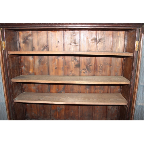 126 - Vintage oak glazed bookcase over double door cupboard, approx 120cm wide x 196cm high.